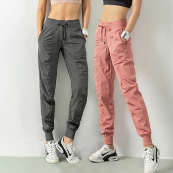 Sweatpants النسيج الرباط تشغيل الرياضة ركض النساء الجافة سريعة الرياضية اللياقة البدنية في الصالة الرياضية مع اثنين الجانب جيوب السراويل ممارسة